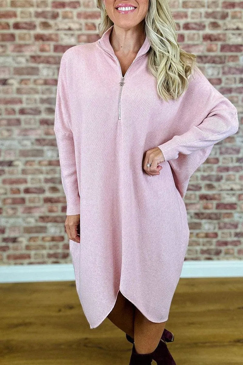 Women's solid colour loose knitted dress with raglan sleeves and a front zip closure.