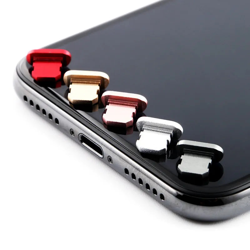 Aluminium alloy iPhone charging port dust plug in multiple colours including gold, silver, blue, red, grey, black, and rose gold.