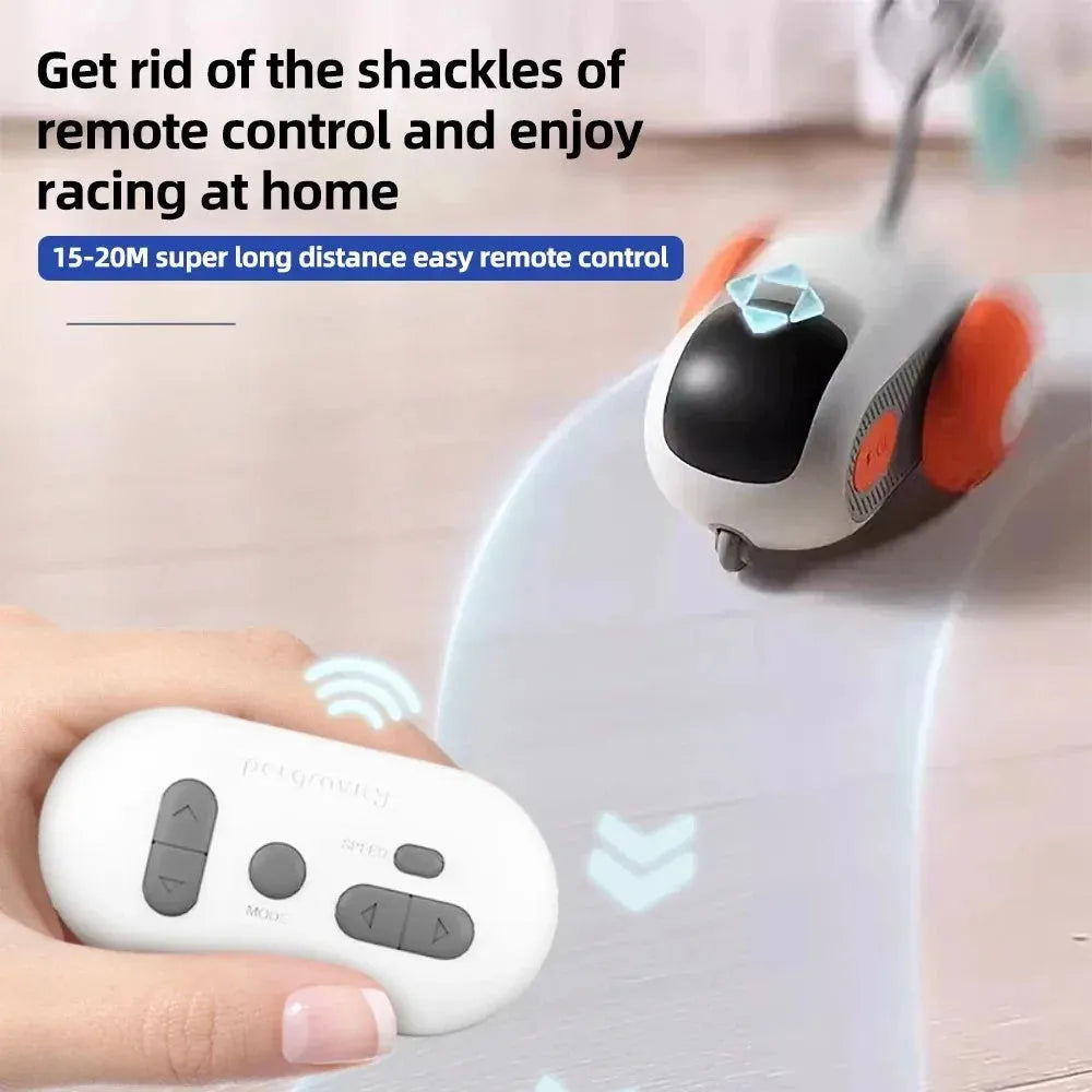 Blue and orange smart remote control cat toy car with feather teaser attachment on a home floor.