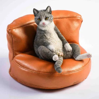 Small resin cat ornament sitting on fabric sofa for car dashboard decoration