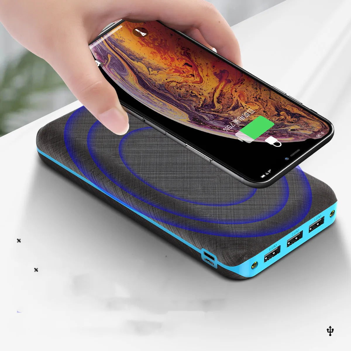 Solar power bank with wireless charging surface, three USB ports, and LED flashlight in black colour