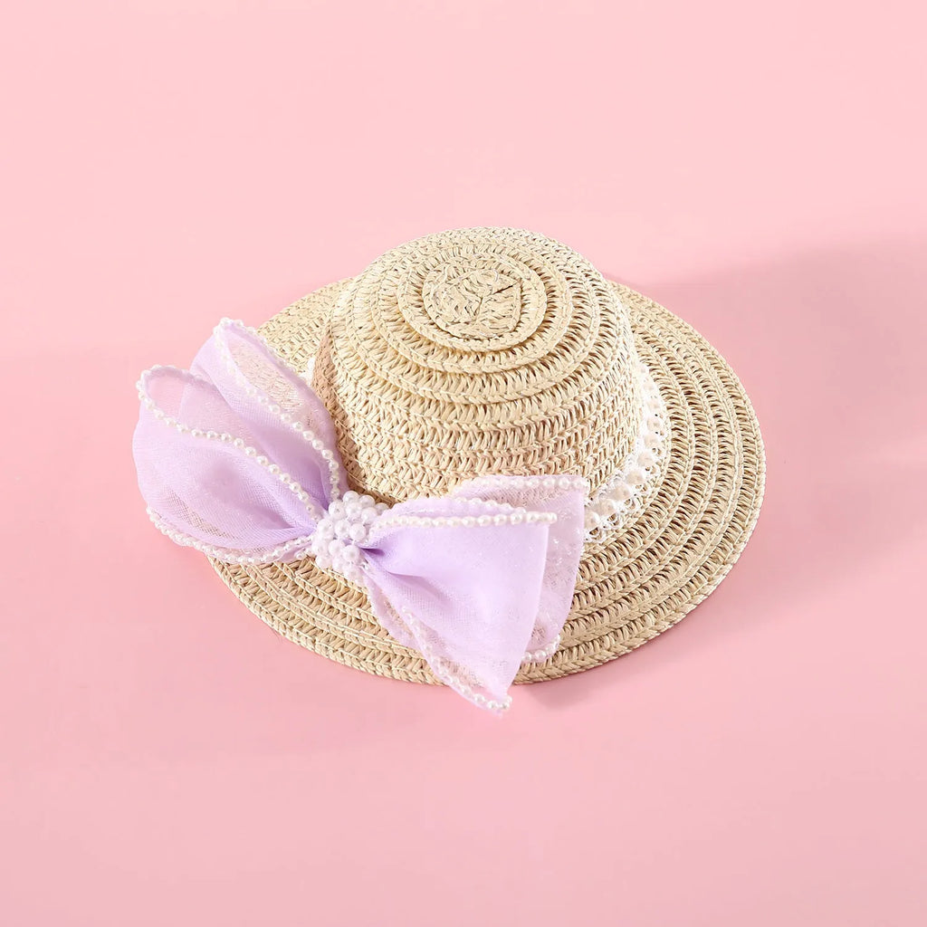 Pink pearl bow woven straw hat for a cat, shown in size S (13cm) on a mannequin head.