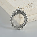 Geometric dragon shape stainless steel earrings in antique silver with hollow-out detail.