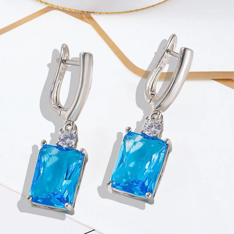 A pair of square geometric copper earrings with a gold electroplated finish.
