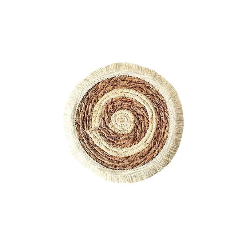 Round Japanese straw placemat with corn rope tassels in natural papyrus colour on wooden table