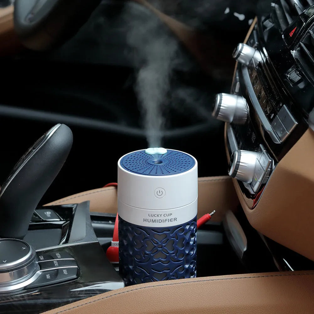 Lucky desktop humidifier 250ml USB powered in black with blue water bottle showing mist output on office desk