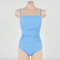 Blue sling style one-piece swimsuit with belly pleating on a mannequin.