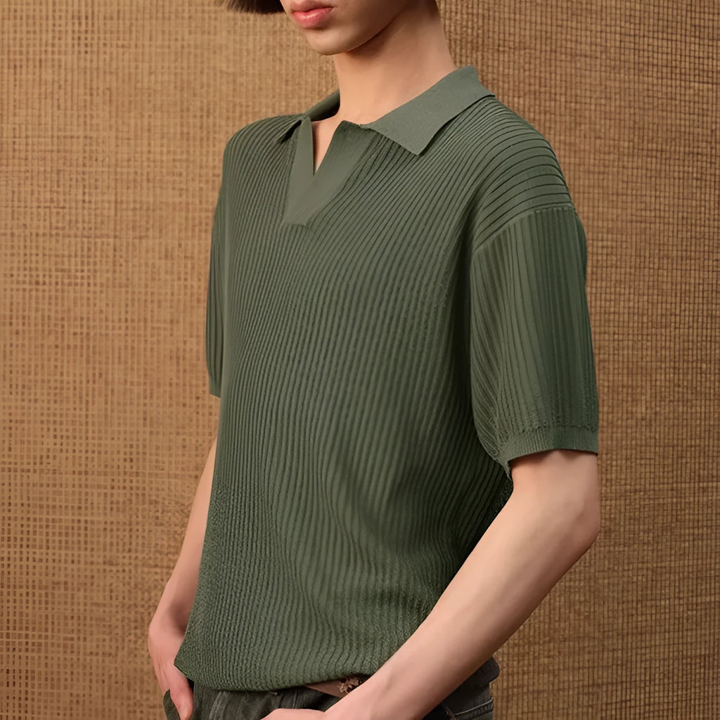 Man wearing a creamy-white loose-fit polo shirt with a striped collar and short sleeves.