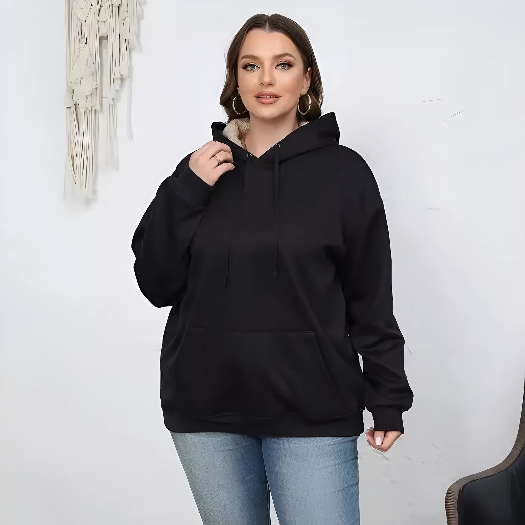 Women's loose black hooded sweater with pockets and a textured 3D pattern