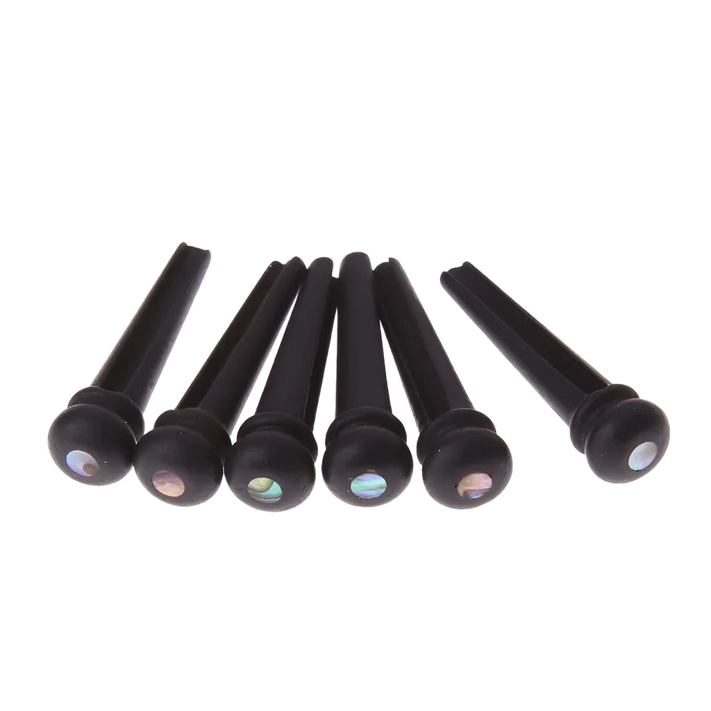 Six solid ebony guitar string nails with matt black finish for folk acoustic guitars.