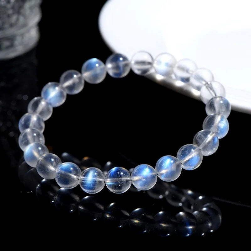 Natural cream coloured crystal bracelet with smooth ground beads, shown in a minimalist unisex style.