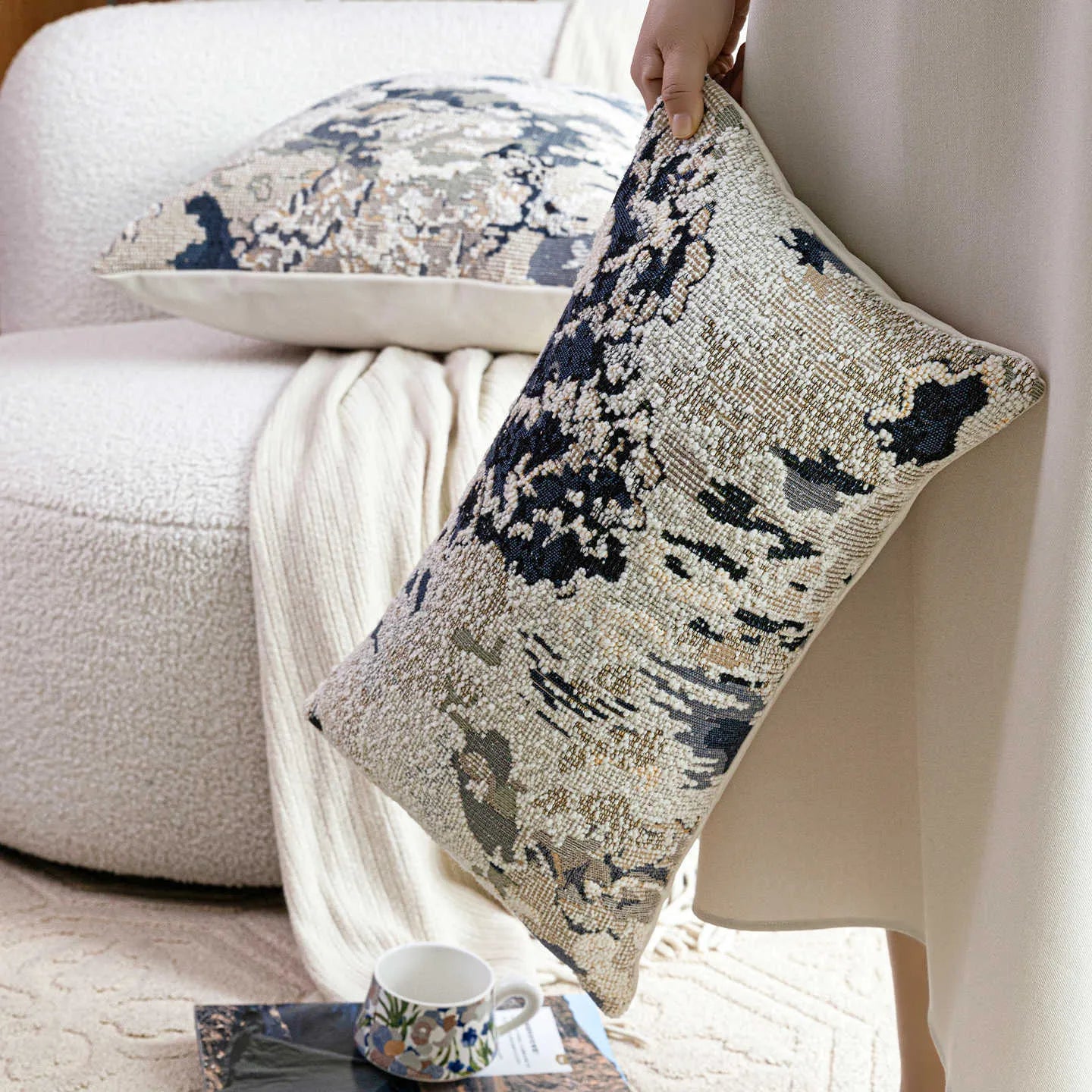 Antique blue cushion with embroidered floral pattern in Chinese style on a sofa