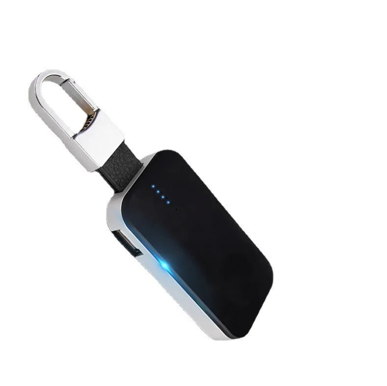 Black Apple Watch portable wireless power bank on a keyring showing compact size