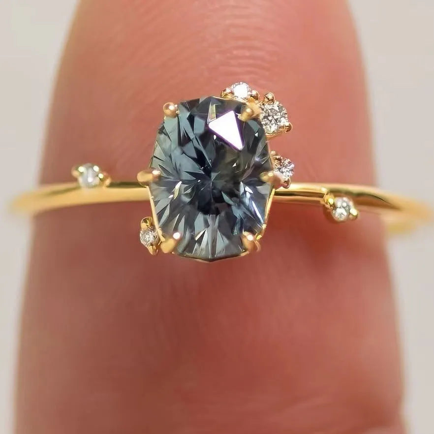 Gold-plated women's ring with flower shape and green zircon stone, shown as a pair.