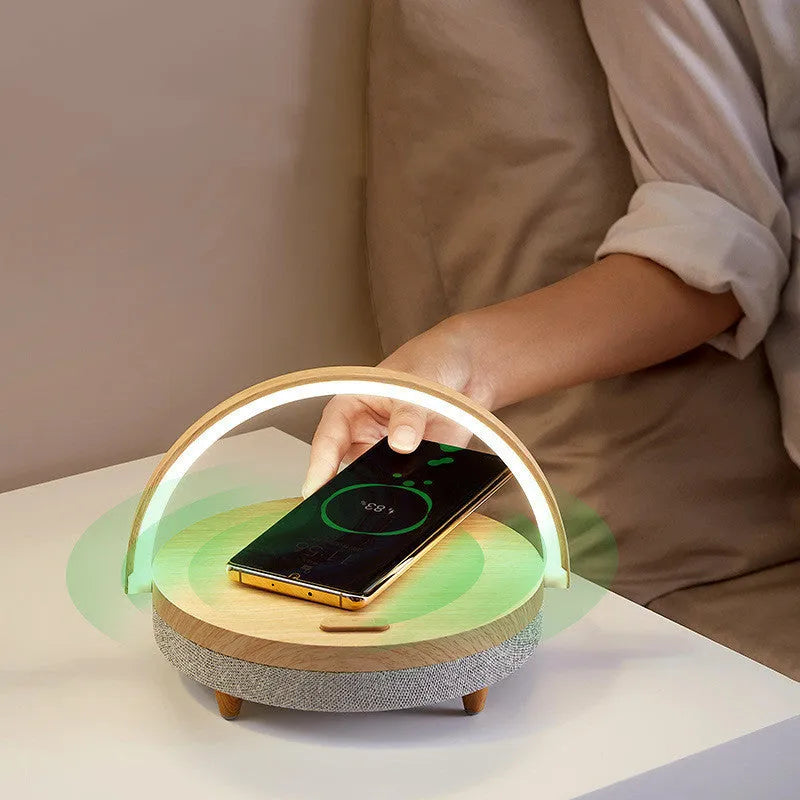 Wireless charging LED night light with Bluetooth speaker and integrated mobile phone holder in marble pattern finish