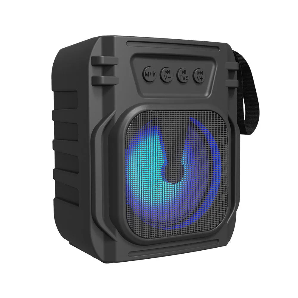 Compact portable Bluetooth speaker in neutral colour with USB charging cable.