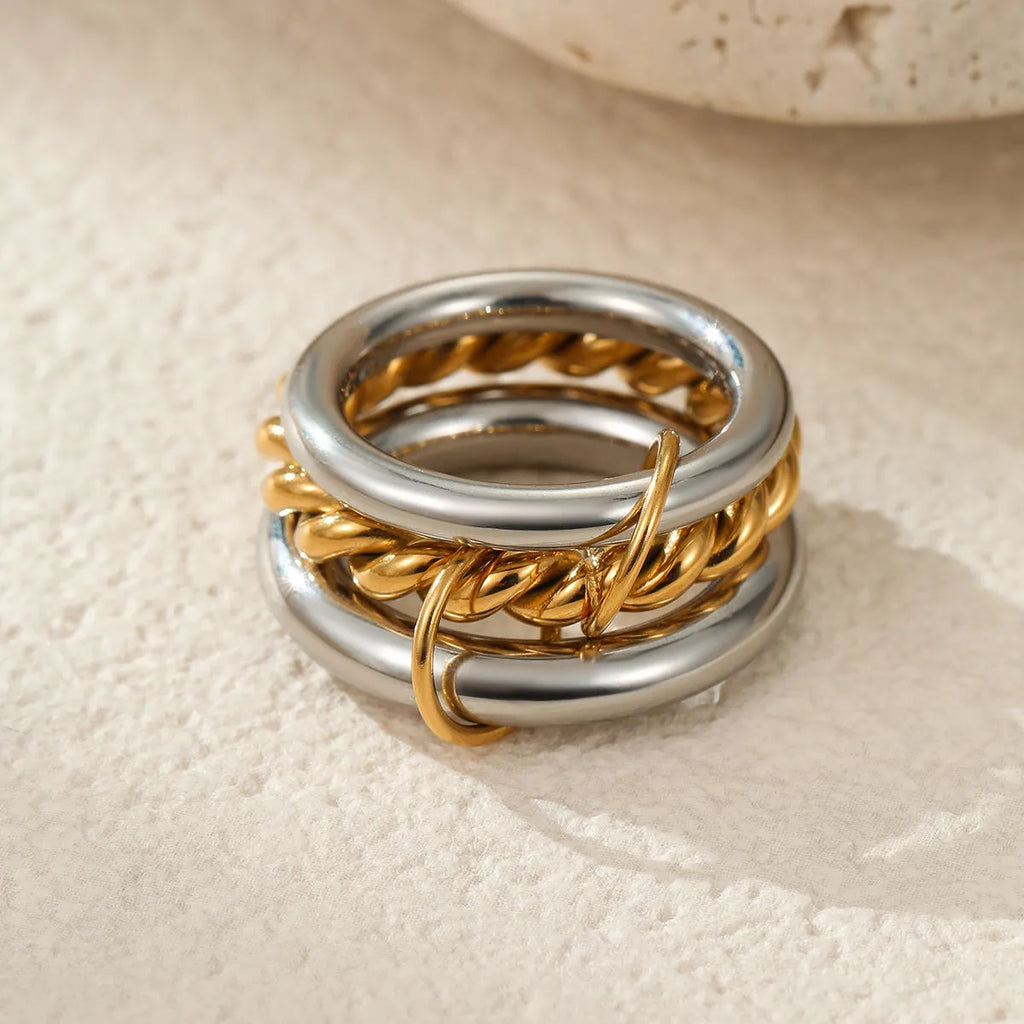 Stacked gold plated stainless steel rings with an exaggerated wide band design, shown in a free size.