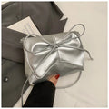 Women's black PU leather crossbody underarm bag with horizontal square shape and visible sewing lines.