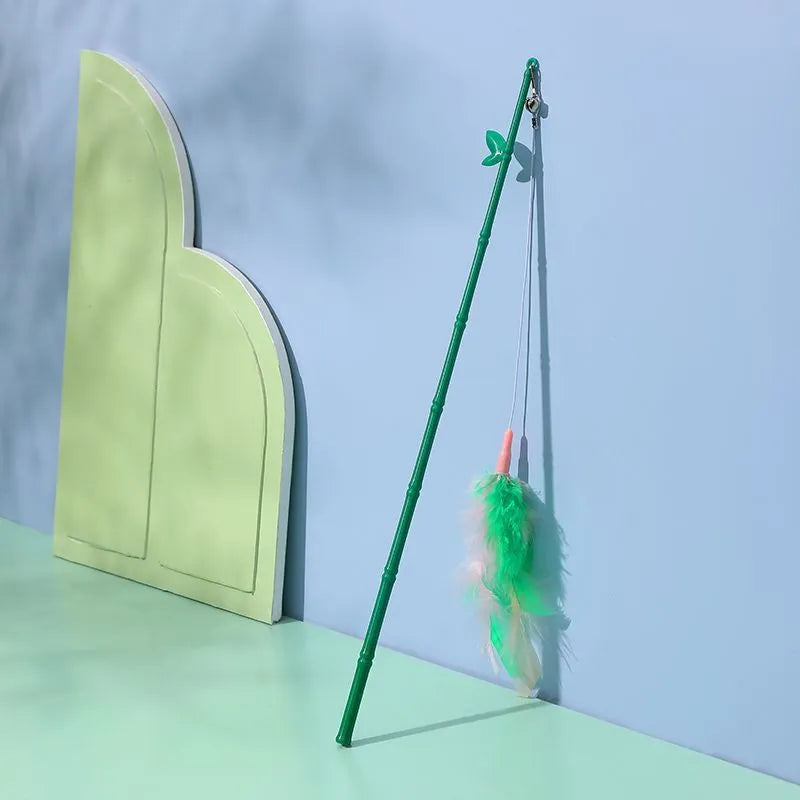 Green cat feather wand toy with bells and feathers on a durable wand with comfortable grip handle