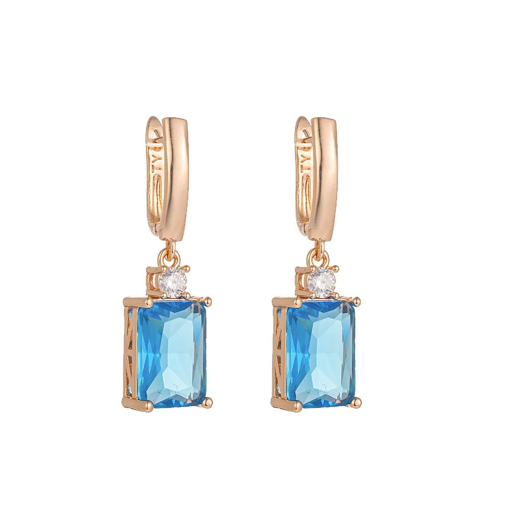 A pair of square geometric copper earrings with a gold electroplated finish.