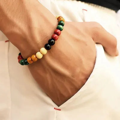 Natural lava stone beaded bracelet for men and women on a neutral background.