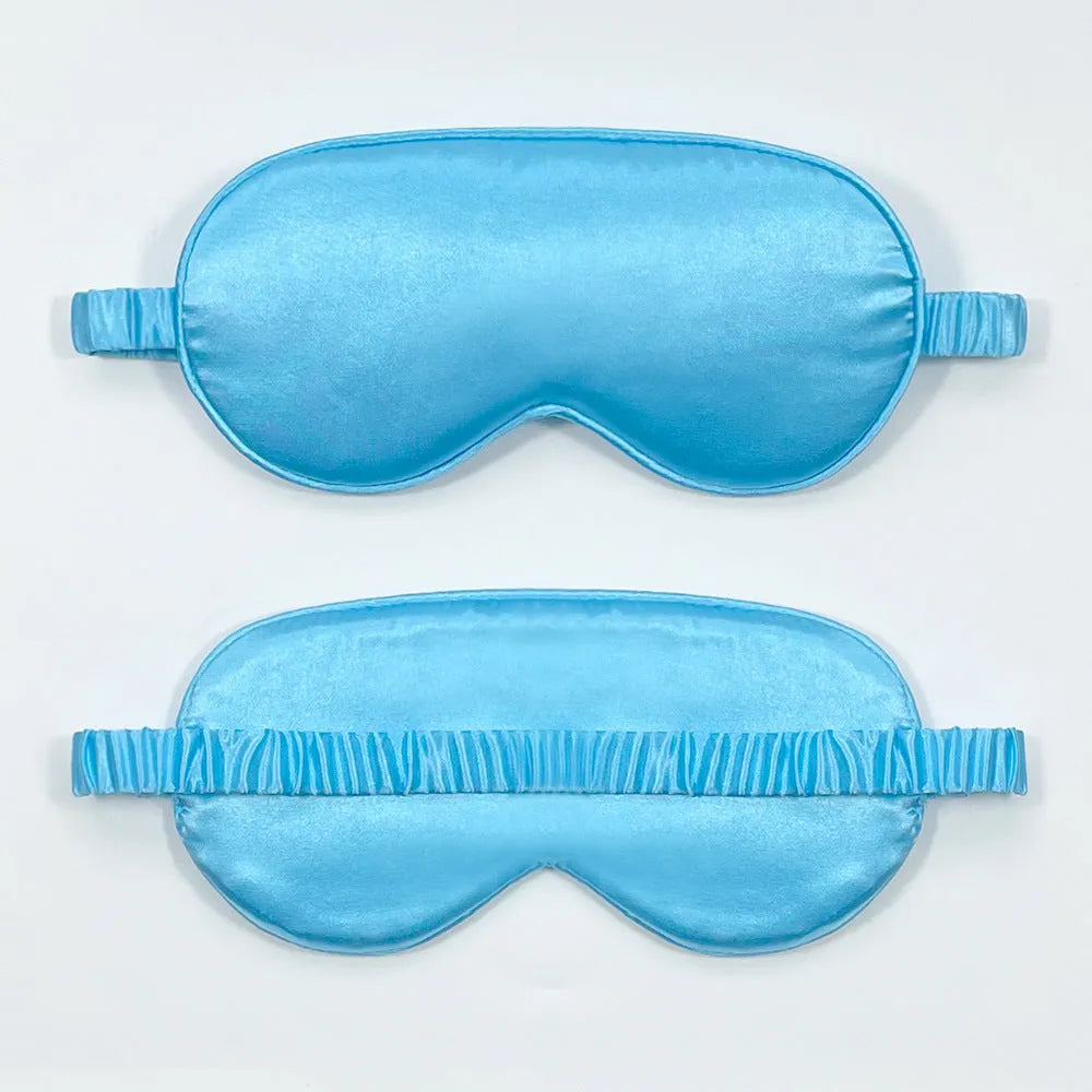Double-sided silk-like sleep mask in rayon satin, shown in multiple colour options on a white background.