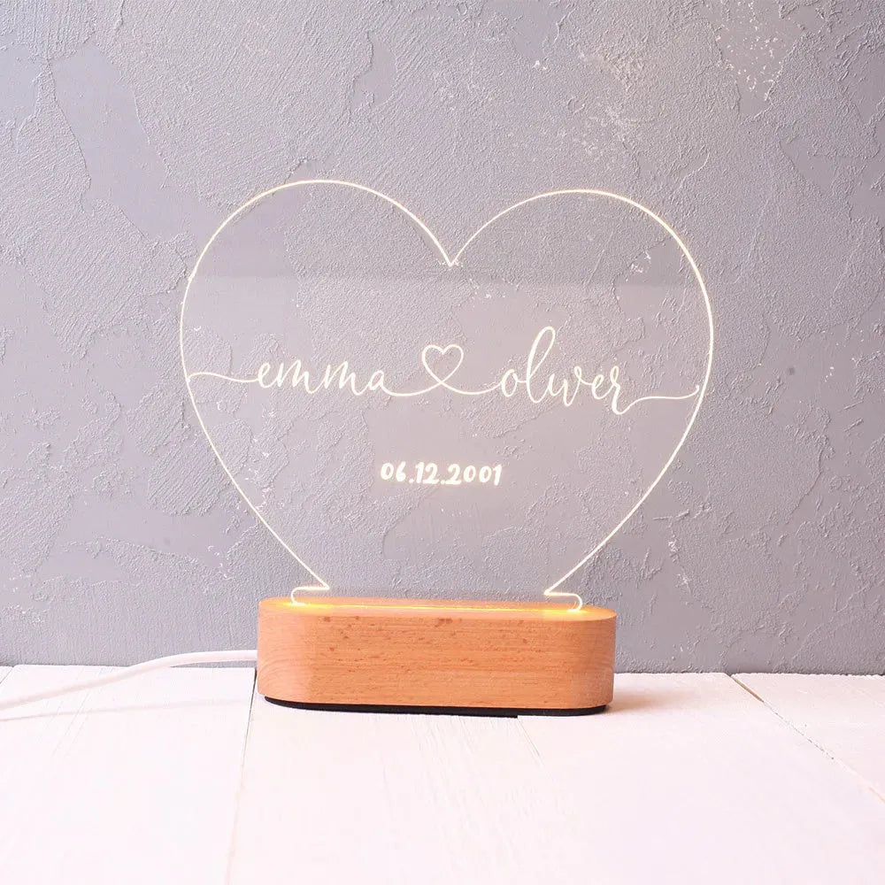 Custom acrylic LED night light displaying personal names and date, 20cm by 11.5cm, with USB cable.