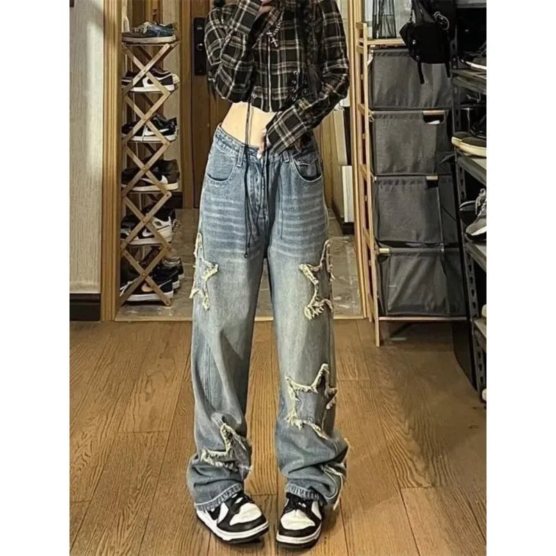 Blue high-waisted wide-leg denim trousers laid flat, showing straight cut and front detail.