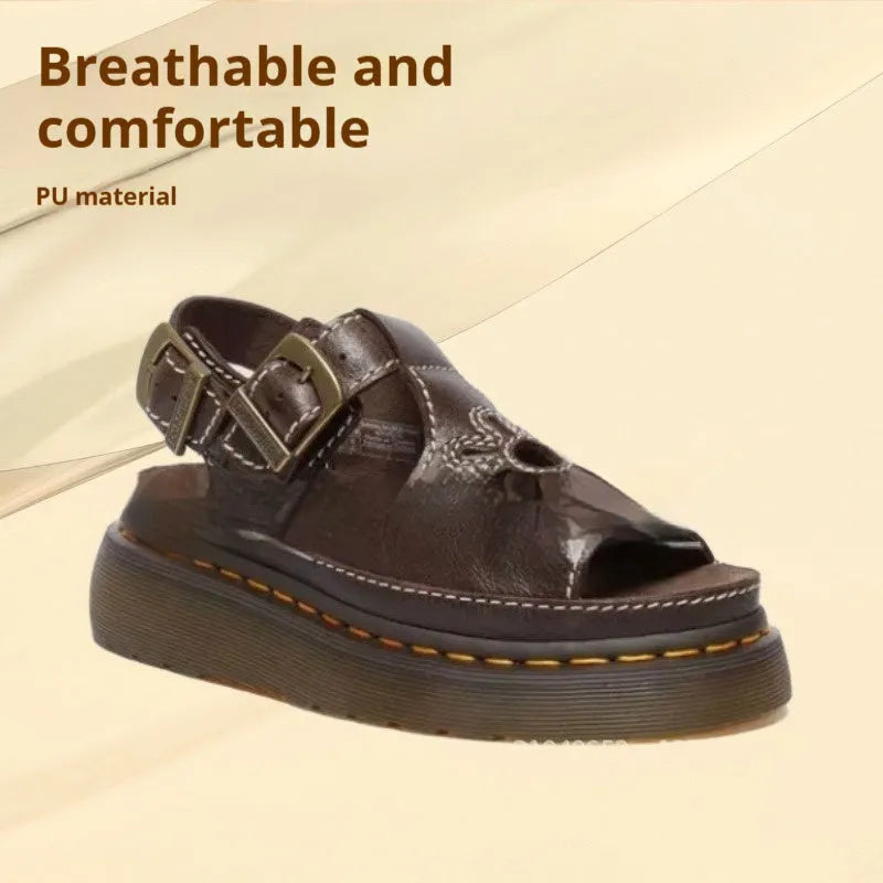 Men's black embroidered floral beach sandals with flat heel on a sandy background.