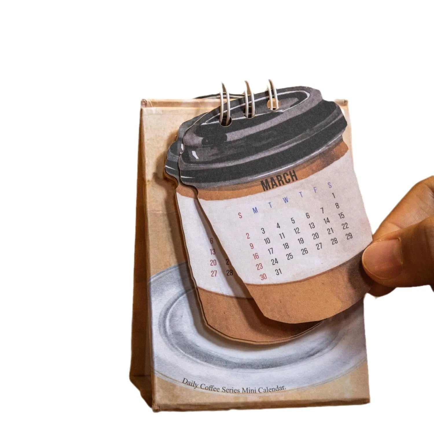 Mini coffee desk calendar 2025 with four design options on small desk surface