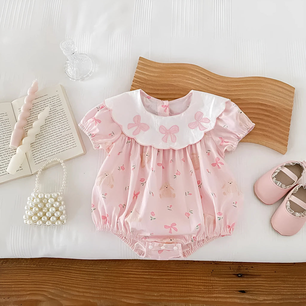 Pink cotton triangle romper jumpsuit for baby girl with three bow details, short sleeves, suitable for height 66-90cm