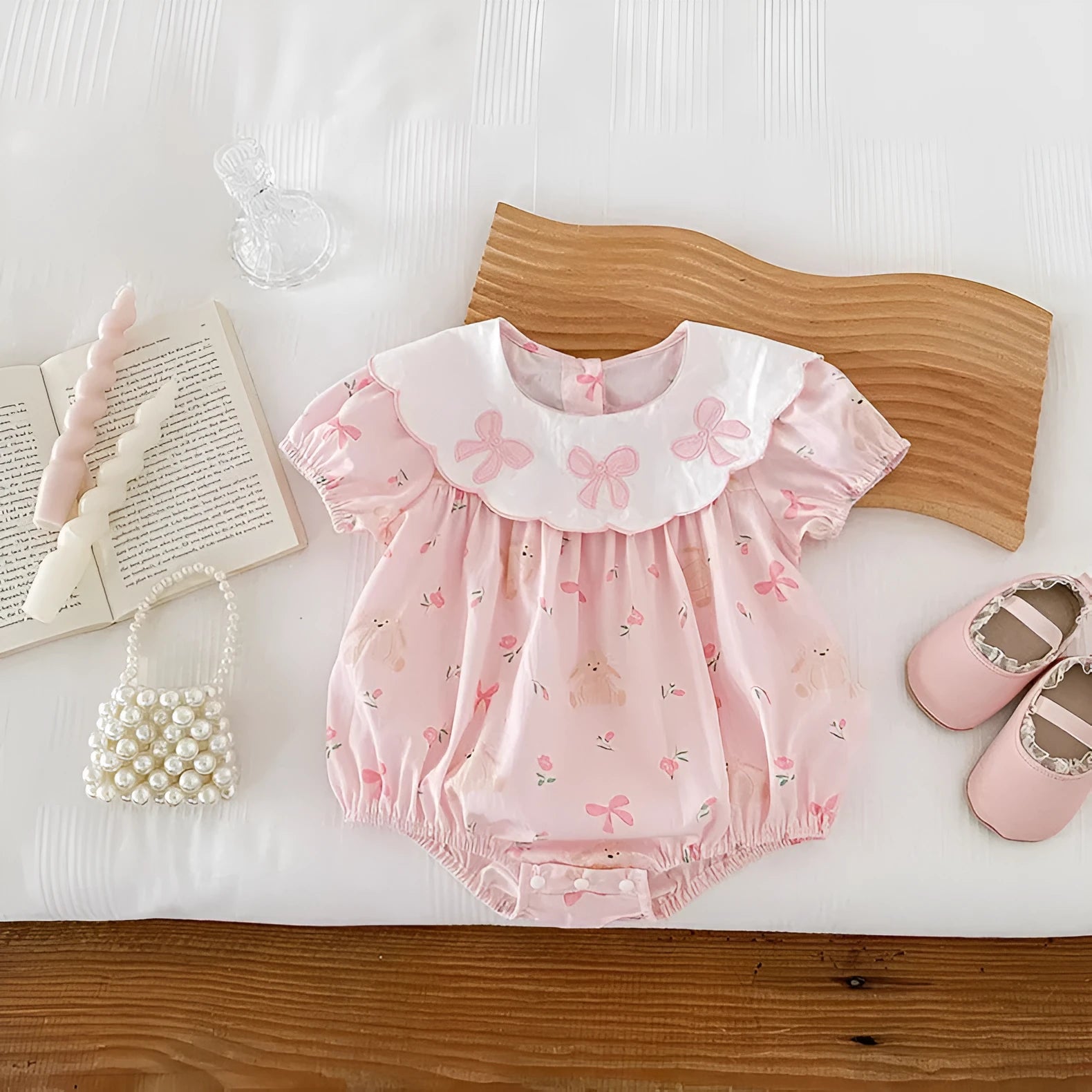 Pink cotton triangle romper jumpsuit for baby girl with three bow details, short sleeves, suitable for height 66-90cm