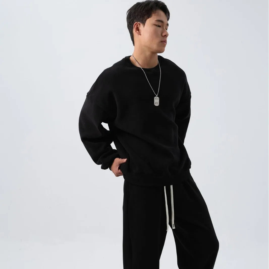 Men's polar fleece sports suit set showing crew neck top with long sleeves and matching padded trousers in winter colours