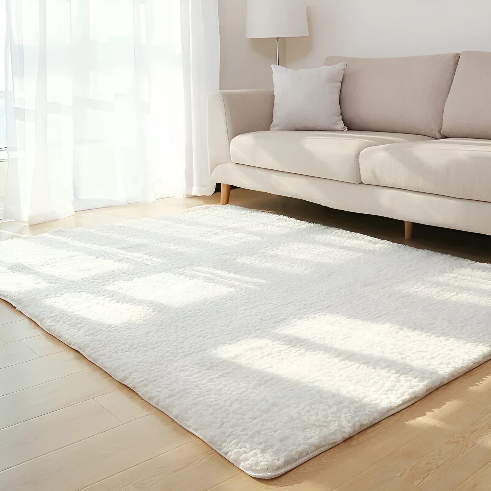 Solid colour fluffy plush carpet with non-slip dots on bottom, shown in beige on a wooden floor.