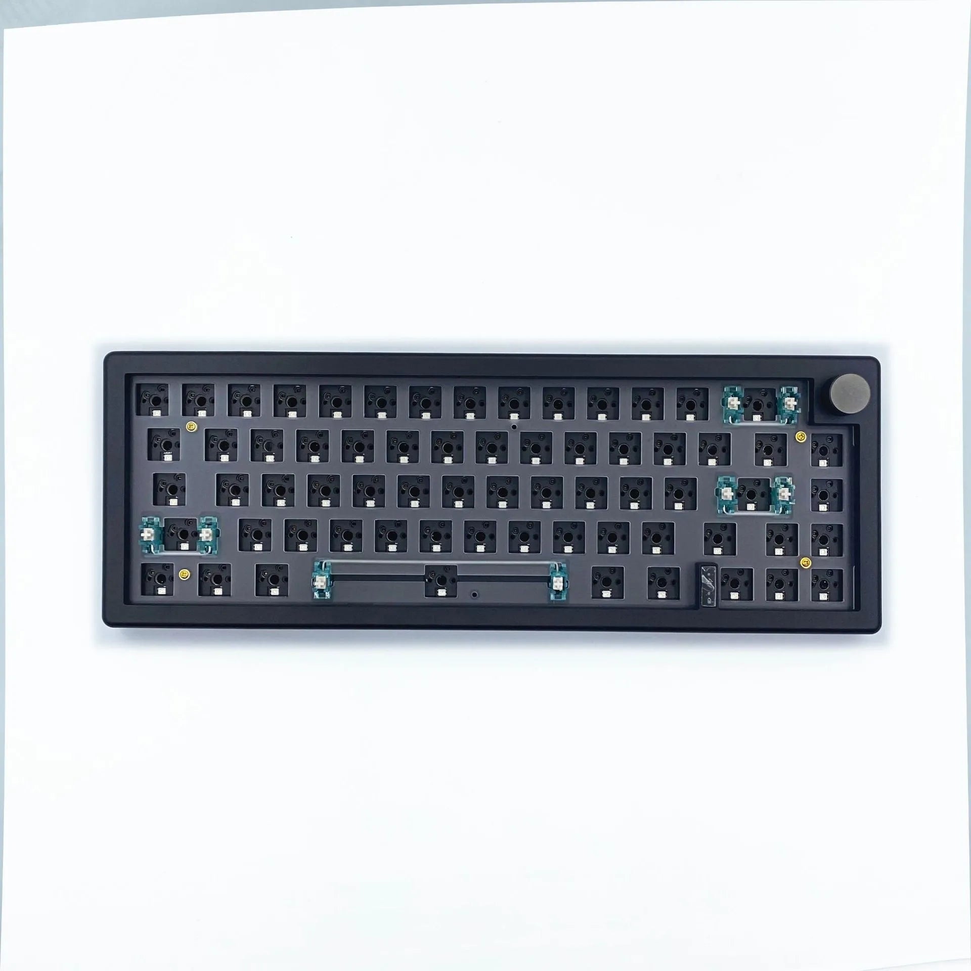DIY mechanical keyboard kit components with RGB keys and knob on a black ABS case.
