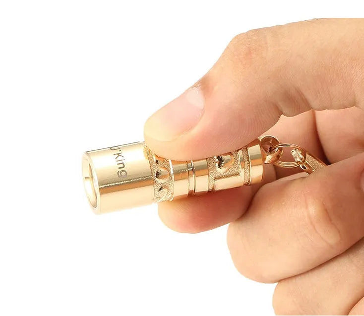Gold zinc alloy waterproof LED flashlight attached to a key ring