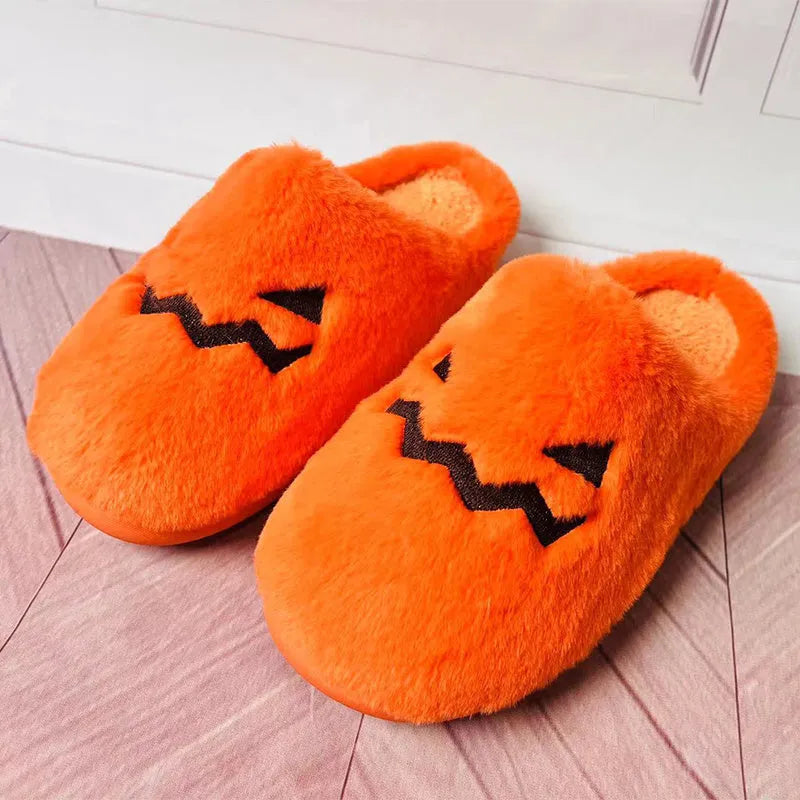Orange coral velvet Halloween pumpkin-shaped slippers with a flat non-slip PVC sole and plush lining.