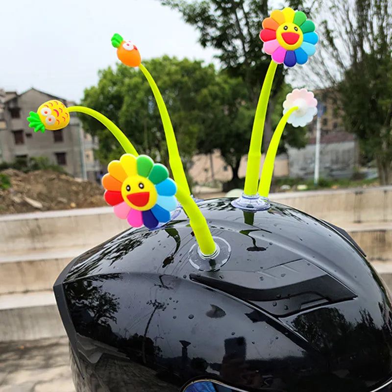 Yellow silicone sunflower decoration with a suction cup base for helmet mounting.