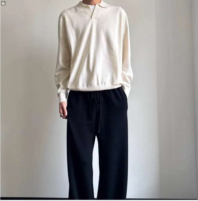 Man's milky white pure wool polo sweater with a lapel collar, shown in a loose fit.