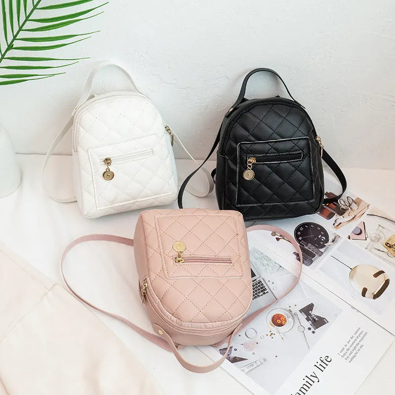 Hardback white PU girls backpack with embroidery, showing front sandwich pocket and soft carry handle.