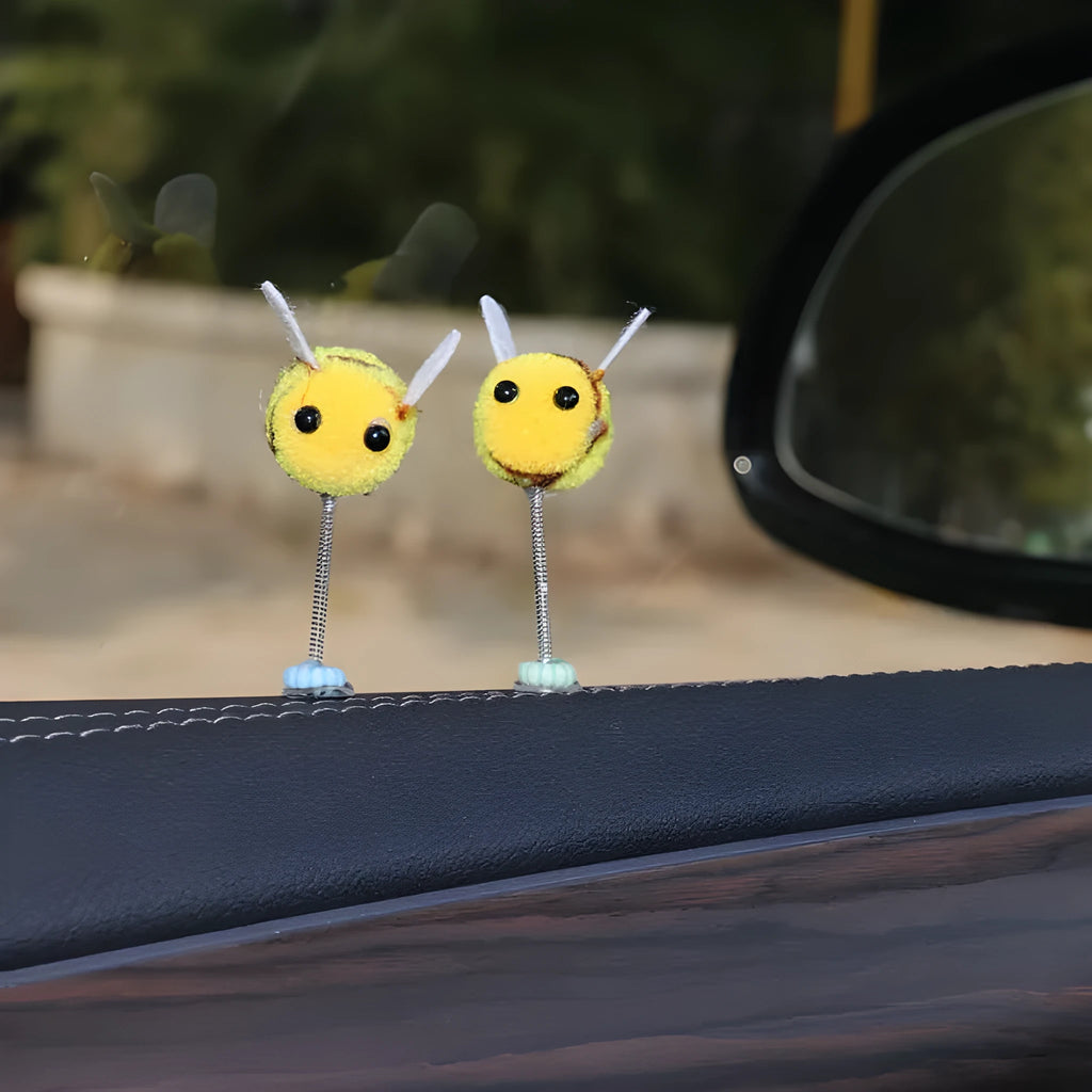 Small yellow and black fur ball bee car ornament with adhesive backing.