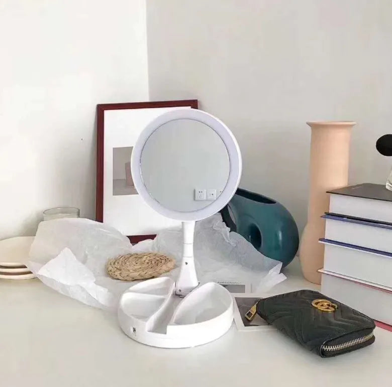 White foldable LED vanity mirror showing 1x and 5x magnification sides and USB charging port.
