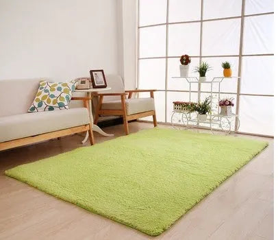 Solid colour fluffy plush carpet with non-slip dots on bottom, shown in beige on a wooden floor.