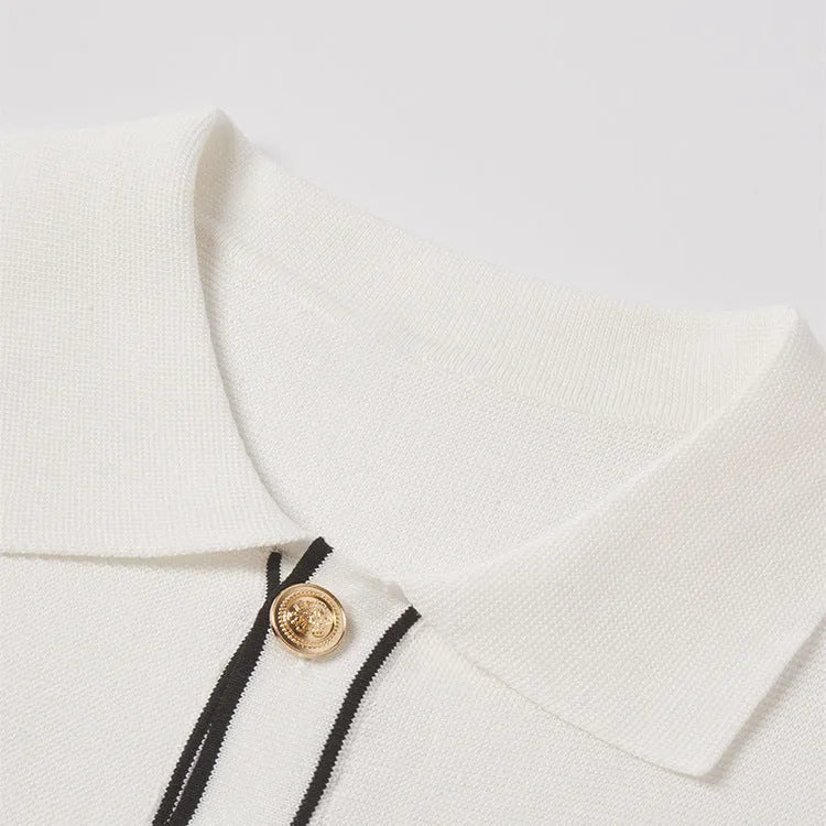 White short sleeve women's cardigan with dark contrast colour lapels laid flat.