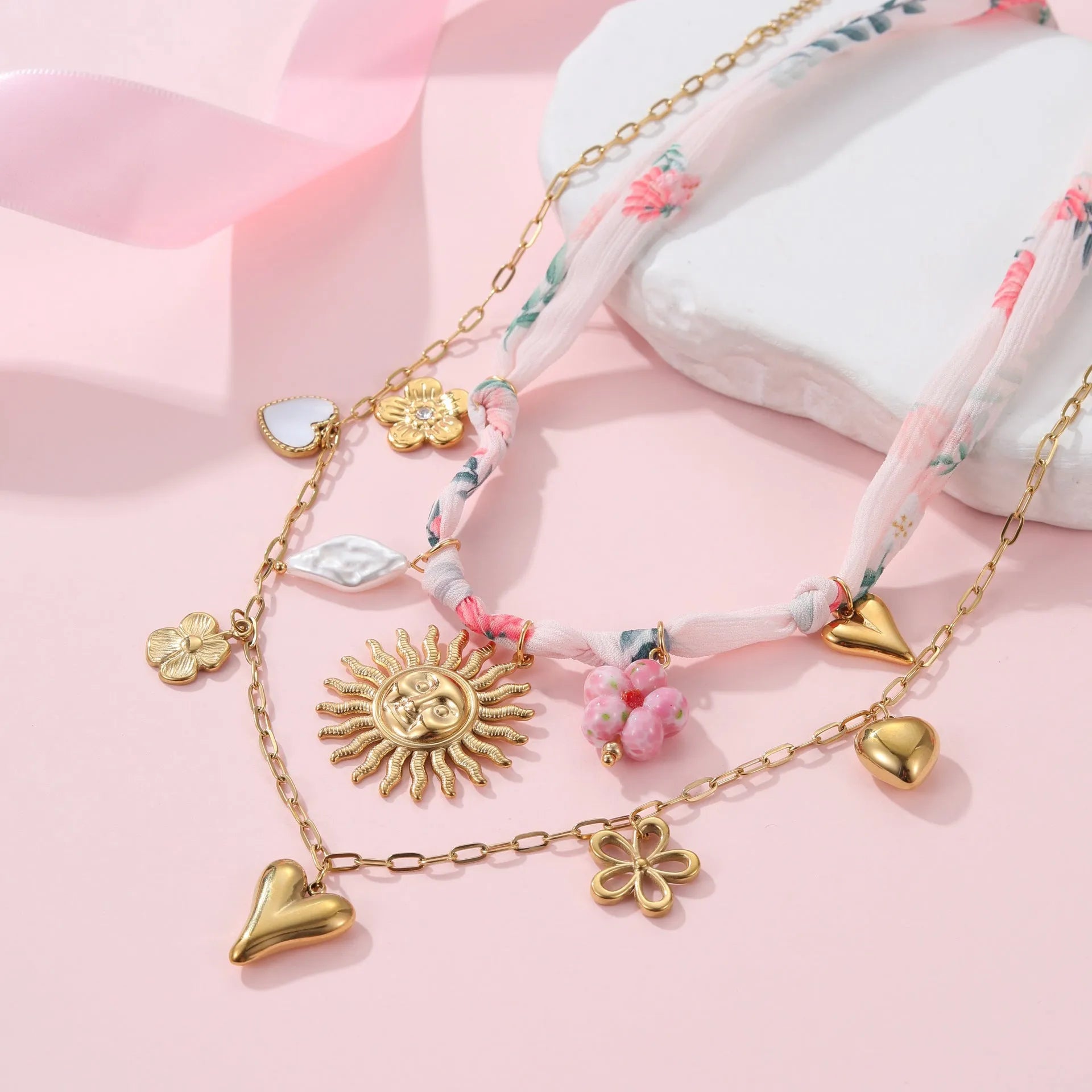 Stainless steel necklace with geometric heart and ribbon sun pendant on adjustable 41-50cm chain