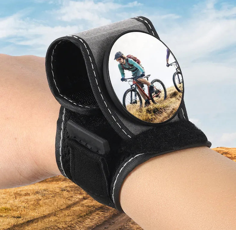 Black nylon wrist-mounted bicycle rear-view mirror with adjustable angle and secure strap for handlebar installation