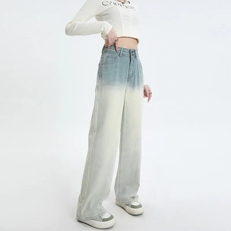 Gradient blue women's denim straight-leg trousers with a wide-leg fit on a hanger