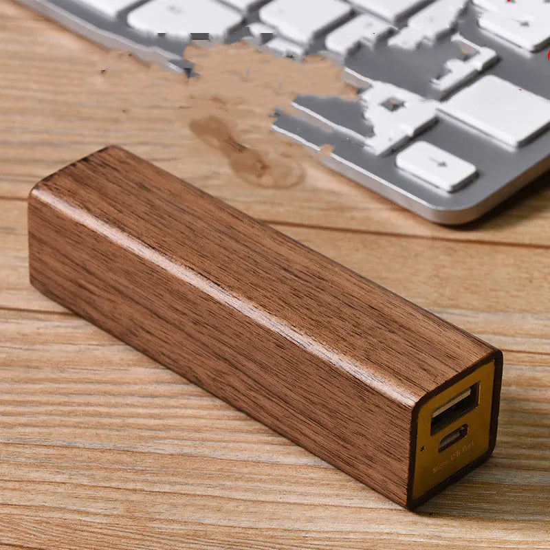 Brown black walnut solid wood portable power bank with 2000mAh capacity.