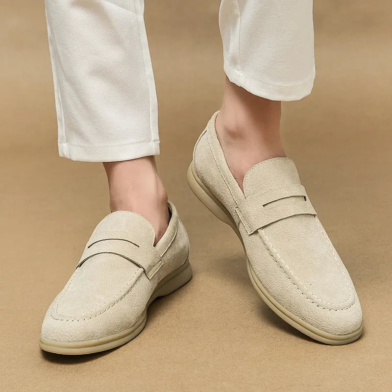Men's beige slip-on leather casual shoes with a round toe and mid-height rubber sole.