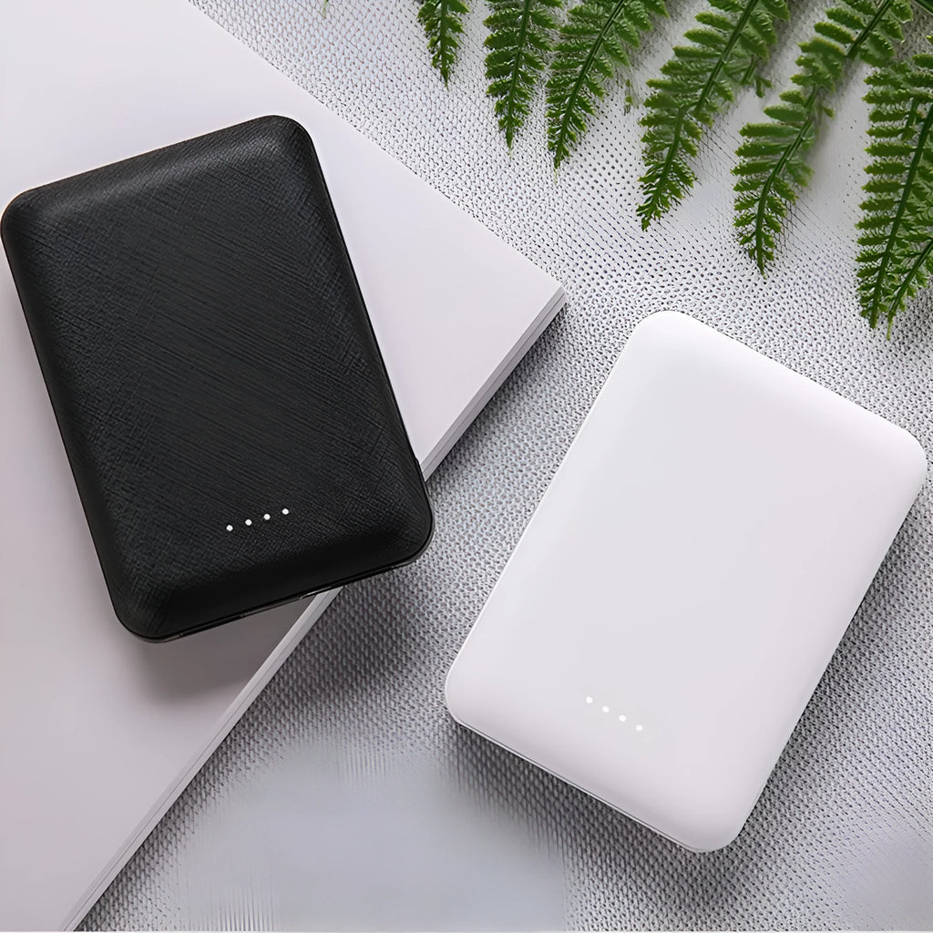Black and white ultra-thin 10000mAh power bank showing multiple USB ports and compact 90x63x22mm dimensions